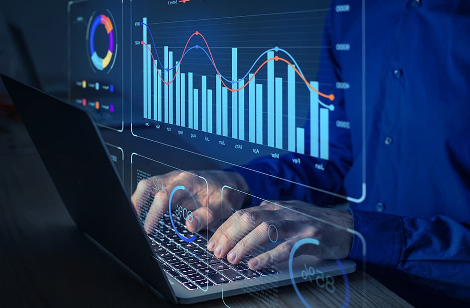 A bar chart on a laptop screen as someone types