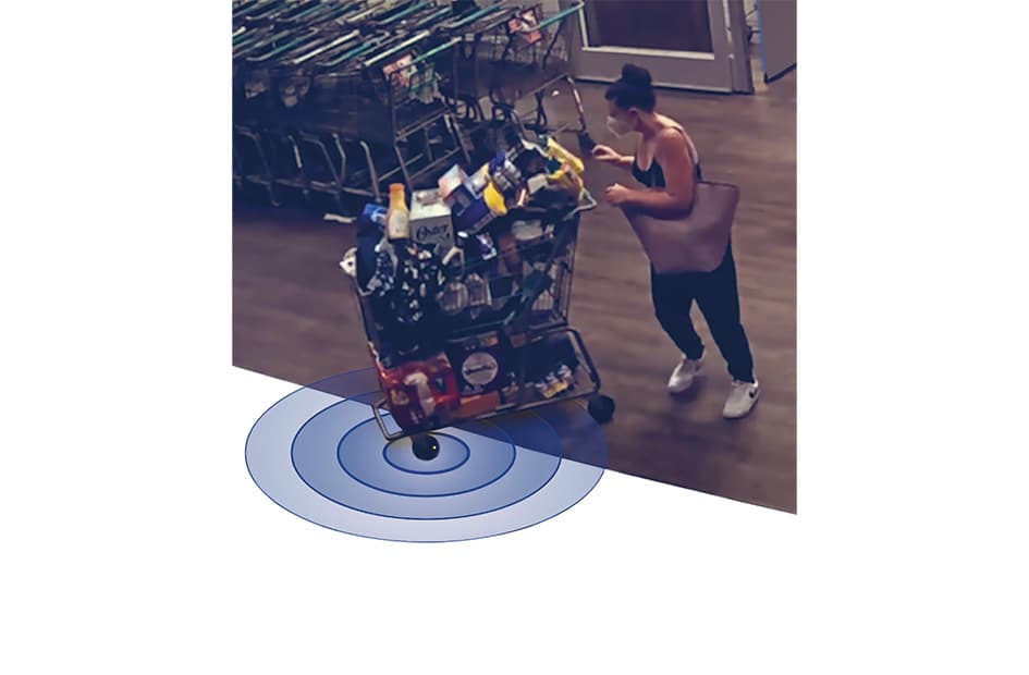A person stopped at a store exit as the trolley wheels lock